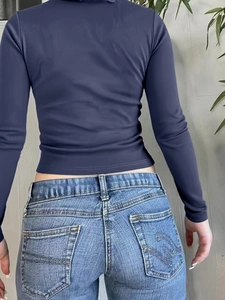 Slim fit deep blue long sleeve top with high neck design shown from the back view