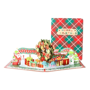 3D pop-up Christmas card featuring festive wreath design and red plaid patterns