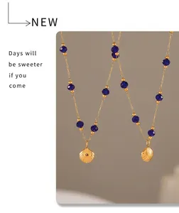 Detail of vintage starfish shell pendant with blue crystal beads on 18k gold chain