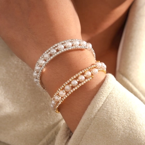 Close-up of triple-layered pearl bracelet with crystals on a woman's wrist