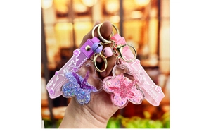 Detail of pink and purple starfish oil-filled keychains with liquid glitter and sequins