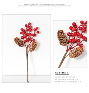 Detailed view of red Christmas berries and natural pine cones with frosted texture accents