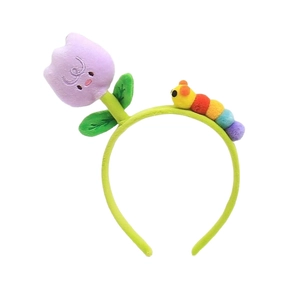 Cute green plush headband featuring a purple tulip flower and rainbow caterpillar ornament