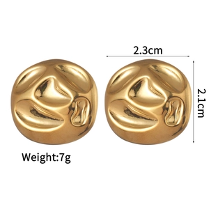 Detailed view of gold irregular wavy earrings with 2.3cm by 2.1cm dimensions and 7g weight