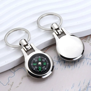 Silver metal compass keychain and bottle opener on a nautical travel map background
