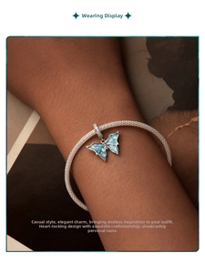 Close-up of 925 sterling silver woven bracelet with blue butterfly charm on model's wrist