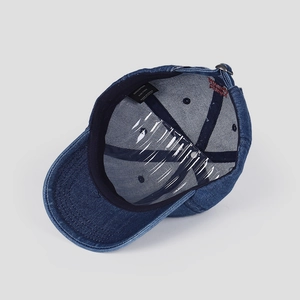 Detailed view of 100% cotton denim baseball cap interior with quality stitching and tag