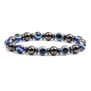 Macro detail of 8mm magnetic hematite beads and blue evil eye charms on elastic bracelet