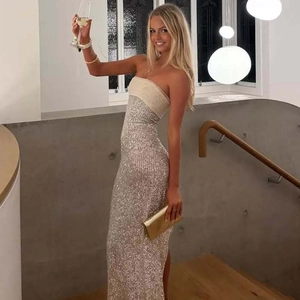 Detail of silver sequined strapless maxi dress featuring a chic beige tube top design