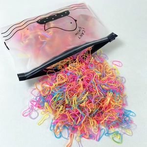 Vibrant macaron color hair elastics pouring from a frosted zipper pouch for kids