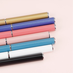 Close-up of portable dual-head nail art pens in multiple colors with metallic finish