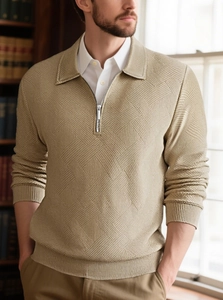 Detailed macro view of the khaki knitted geometric jacquard texture and half-zip collar