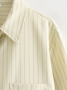 Detailed close-up showing the neck and shoulder of the beige striped cotton blend shirt
