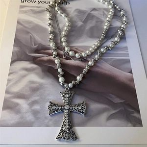 Chic multi-layer cross pendant necklace with pearls and rhinestones on art magazine