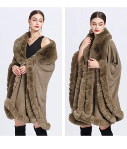 Detail of a brown knitted poncho with a plush faux fur collar and trim on white background