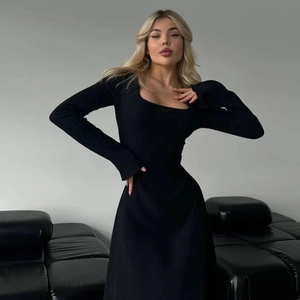 Detail of square neck and lace-up design on this elegant slim black long sleeve dress