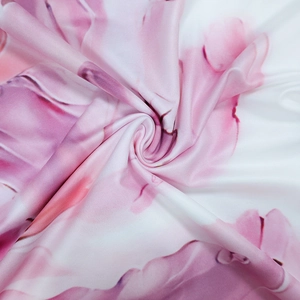 Detail of pink and white watercolor printed fabric with smooth texture and soft folds