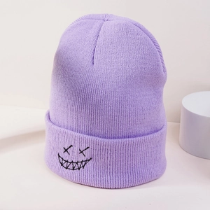 Close-up of purple knit beanie with black embroidered ghost face in street style