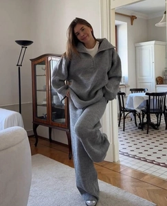 Detail of grey ribbed knit loungewear set with half-zip collar and wide-leg trousers