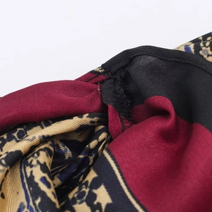 Detailed close-up of paisley pattern fabric with premium stitching and silky texture