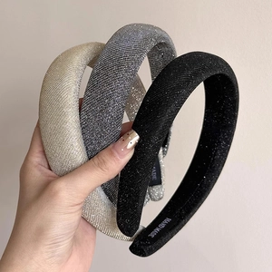 Three sparkling thick headbands in champagne, silver, and black with a metallic glitter finish