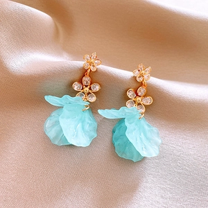 Detailed close-up of French floral earrings with mint green petals and gold plating