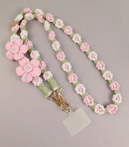 Close-up of hand-woven daisy phone lanyard with pink flowers and gold metal clasp