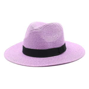 Detail view of a lavender straw Panama hat with a classic black grosgrain ribbon band