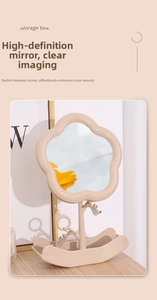 Detail of flower-shaped vanity mirror with storage base and hooks for jewelry