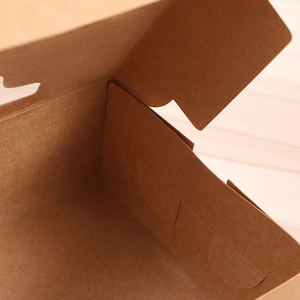 Detail shot showing the fold lines and corrugated texture of the kraft paper gift box