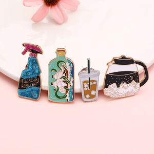 Creative enamel pin set featuring spray bottle and coffee pot designs on a white plate