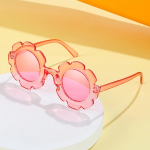 Stylish flower-shaped kids sunglasses in pink orange gradient on creative display