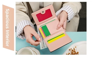 Detailed view of pink tri-fold wallet interior with card slots and cash compartment