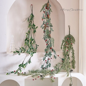 Artificial Christmas swags with pine cones and red berries for festive wall decoration