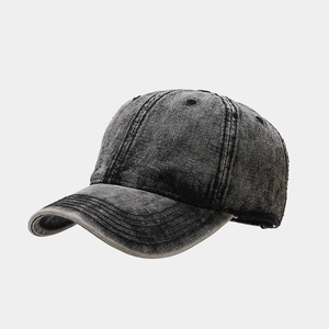 Close-up of washed charcoal grey denim baseball cap with vintage distressed edges