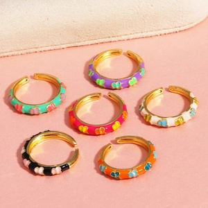 Macro shot of colorful enamel butterfly rings with gold-plated adjustable bands