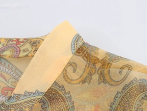 Detail of vintage paisley organza shirt showing the stand collar and refined stitching