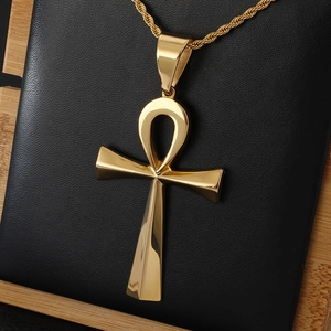 Polished gold ancient Egyptian Ankh cross pendant necklace on a black display stand