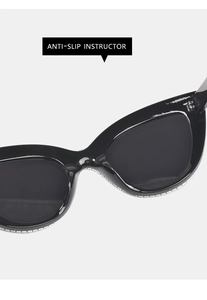 Detail of black cat-eye sunglasses featuring anti-slip pads and rhinestone embellishments