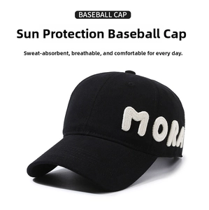 Detail of 3D letter embroidery 'MORA' on a black cotton baseball cap side profile