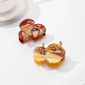 Acorn shaped acetate hair claws in dark brown and light amber with tortoise texture