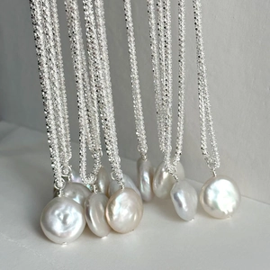 Minimalist S925 sterling silver necklace with sparkling baroque pearls on gray background