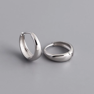 Detailed macro view of S925 sterling silver wide hoop earrings with a clasp closure