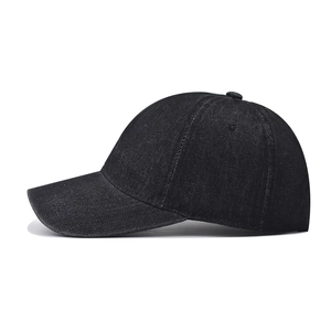 Detailed side view of washed vintage black denim baseball cap with six-panel construction