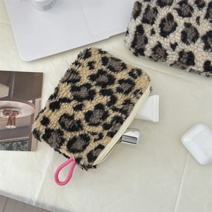 Close-up of plush leopard print storage bag with soft texture and pink zipper puller