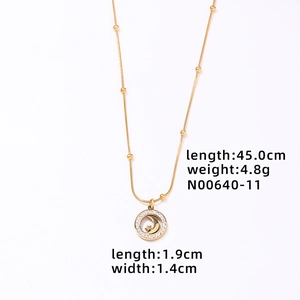 Close-up of gold star and moon pendant necklace with size dimensions and specifications