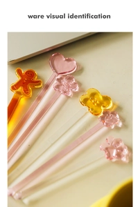 Detailed view of heat-resistant glass coffee stirrers with cute sakura and gingerbread shapes