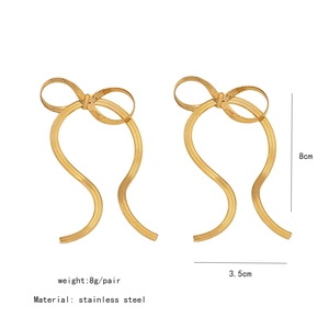 Detailed view of golden stainless steel bow earrings with 8cm height and 3.5cm width specs