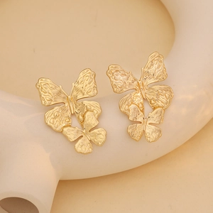 Exaggerated gold butterfly stud earrings with vintage embossed metal texture