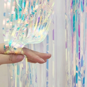 Rainbow tinsel curtain backdrop with iridescent shimmer for birthday and wedding party decor